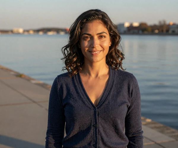 Woman smiling on a waterfront boardwalk, seeking navy dating on MilitaryHearts